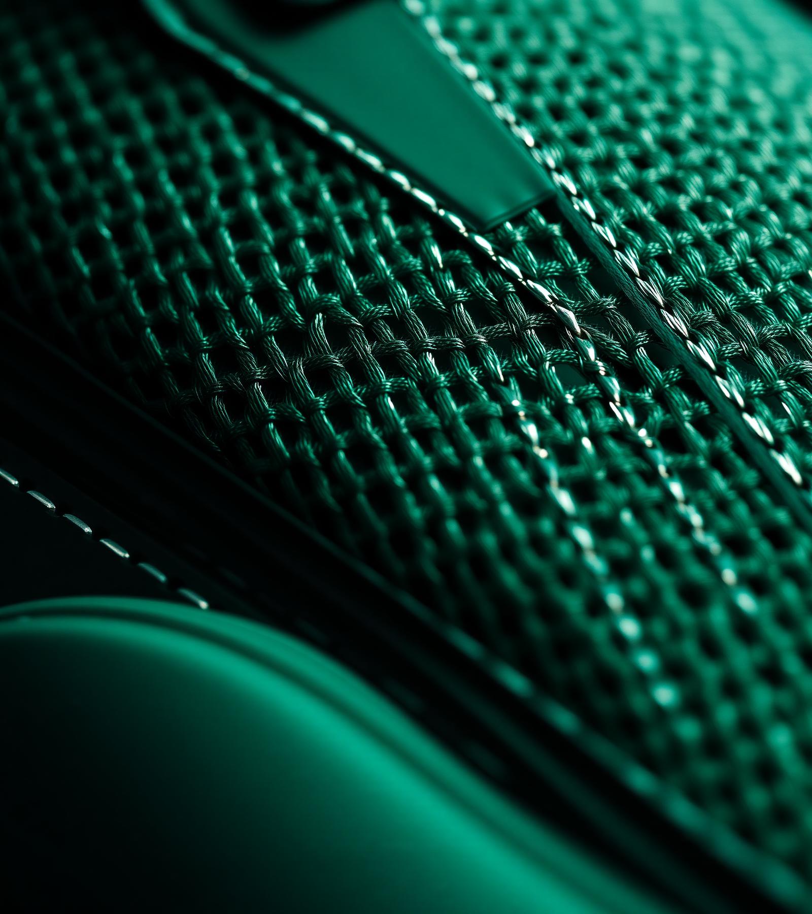 Macro close-up of premium bottle green knit mesh and stitching